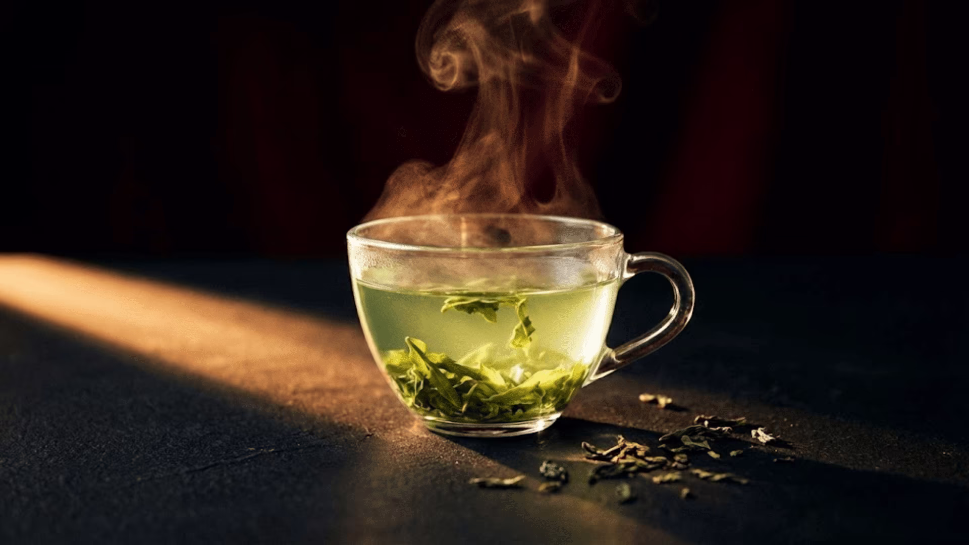 Tea steeping in a glass vessel showing the leaves unfurling