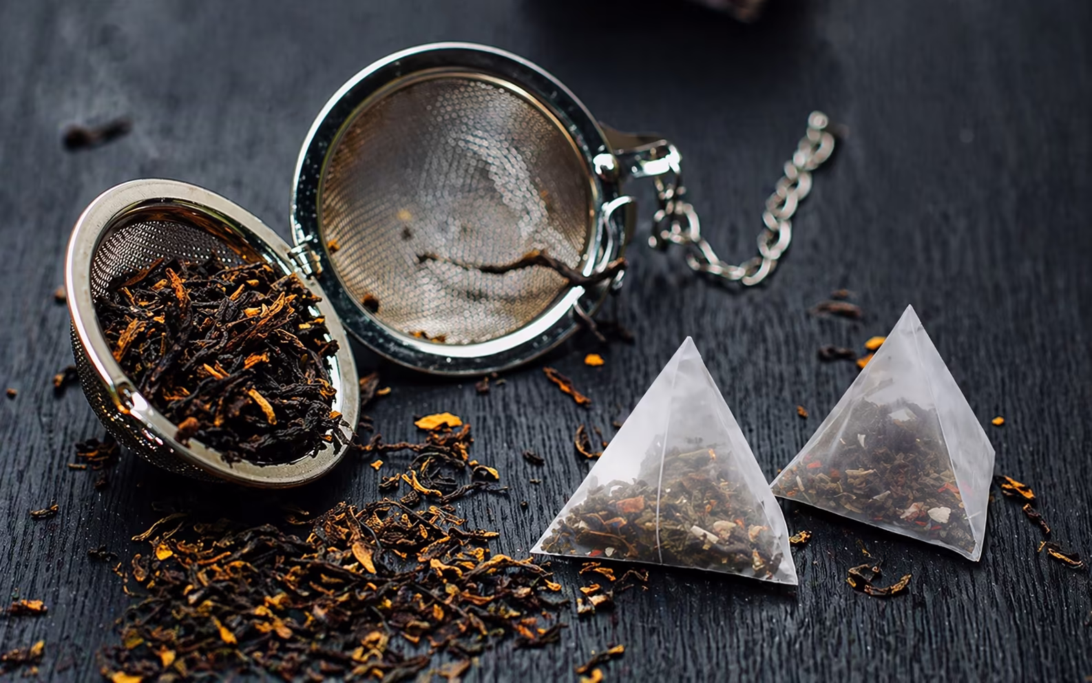 Loose leaf tea next to a tea bag showing the difference in leaf size