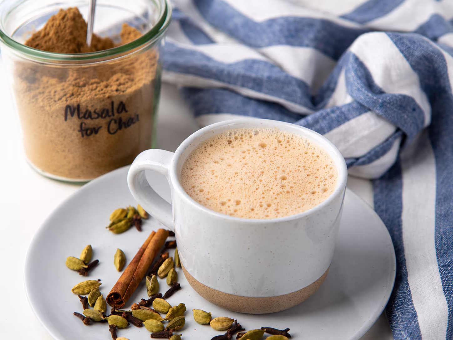 Indian masala chai with spices and milk in a small glass